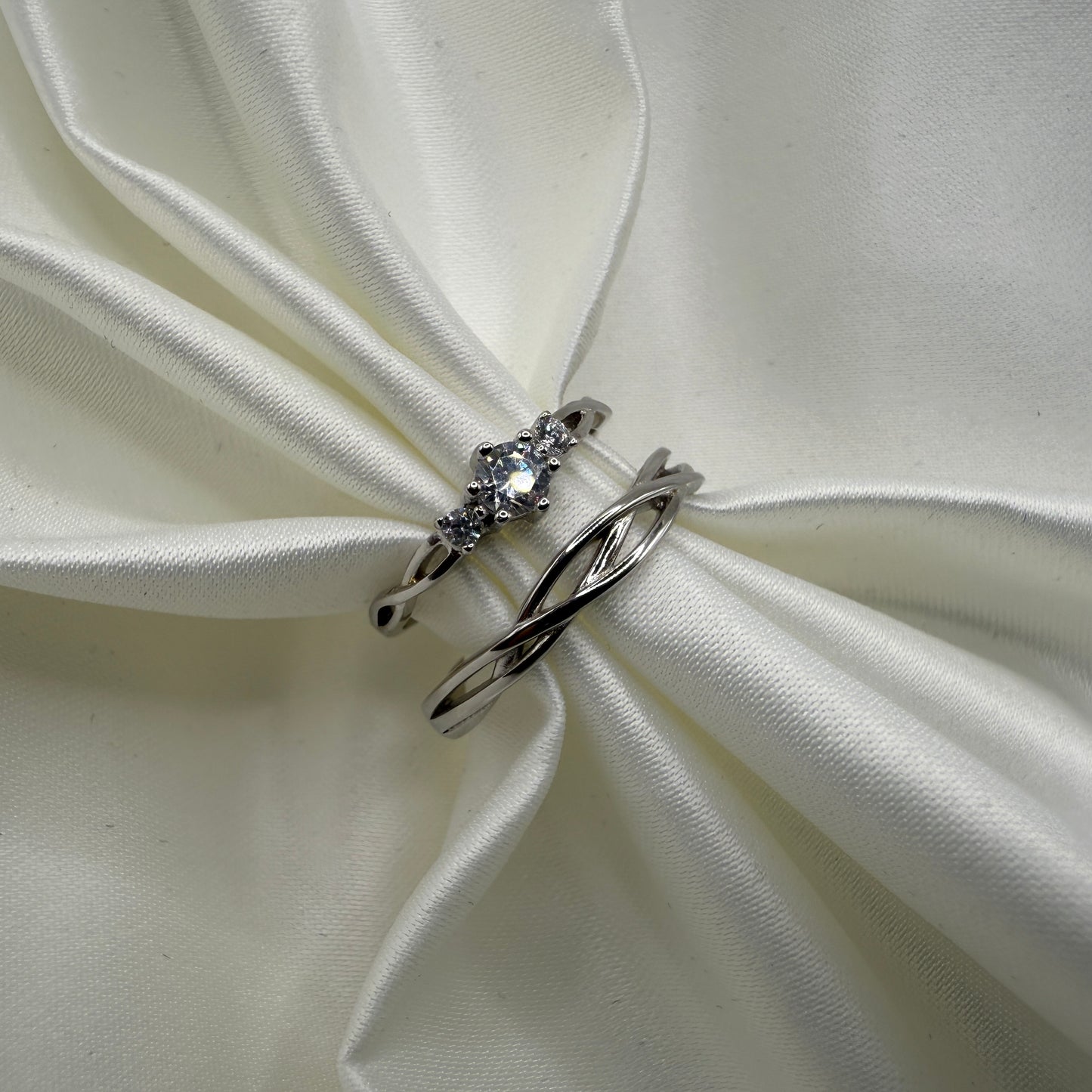 Elyndra 925 sterling silver matching ring set with braided bands and zirconia accents on white satin