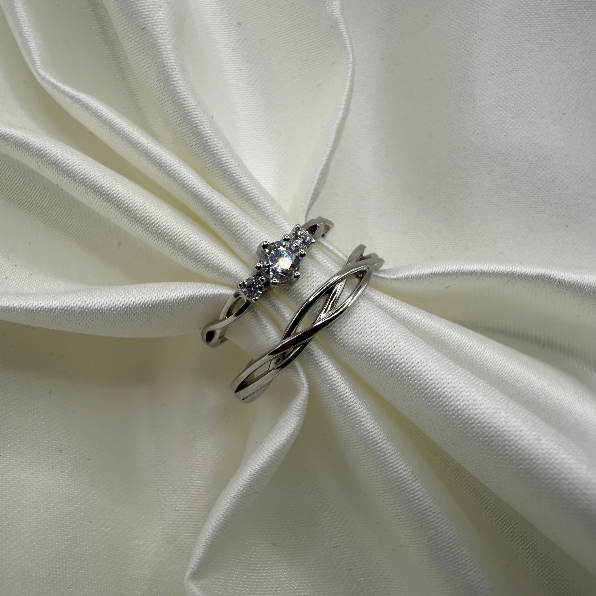 Elyndra 925 sterling silver matching ring set with braided bands and zirconia accents on white satin